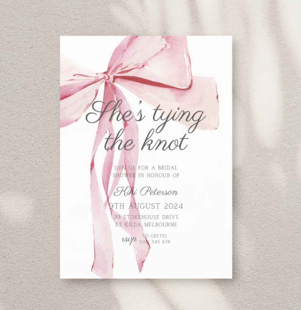 She's tying the know bow themed bridal shower invitations