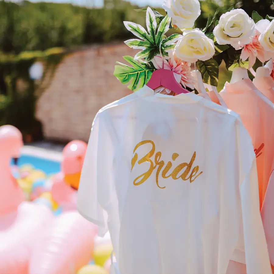 White robe with gold script "bride" written across it.